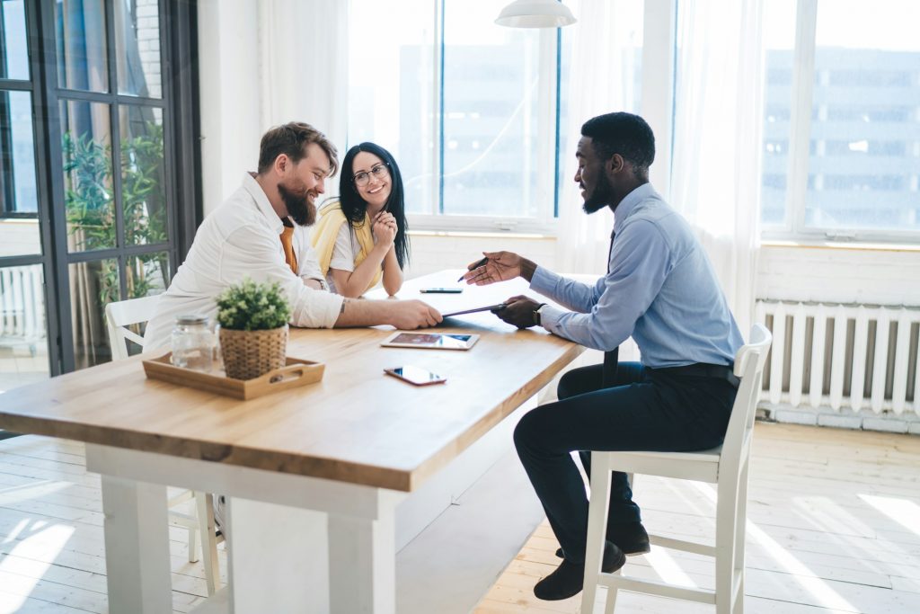 Black agent meeting with happy clients