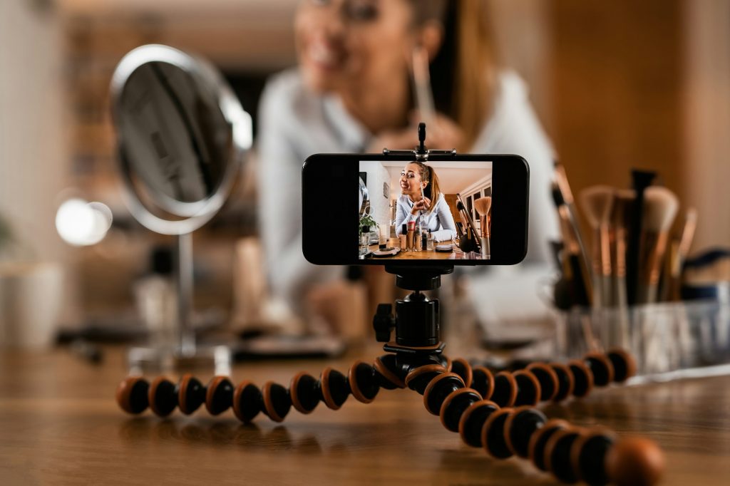 Close-up of make-up artist recording video tutorial about beauty products.