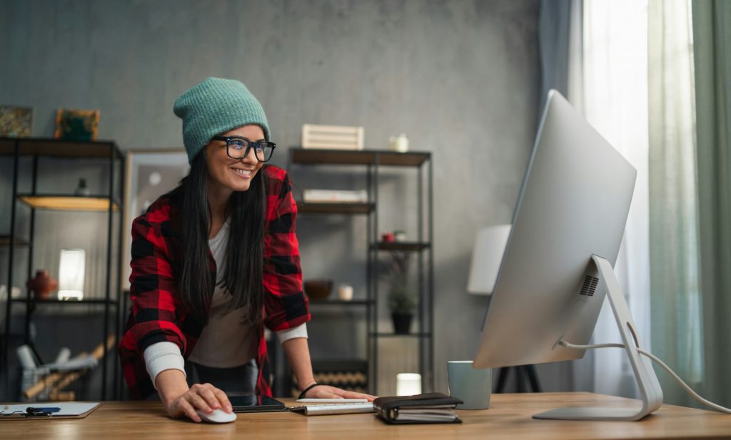 Happy female video editor works indoors in creative office studio